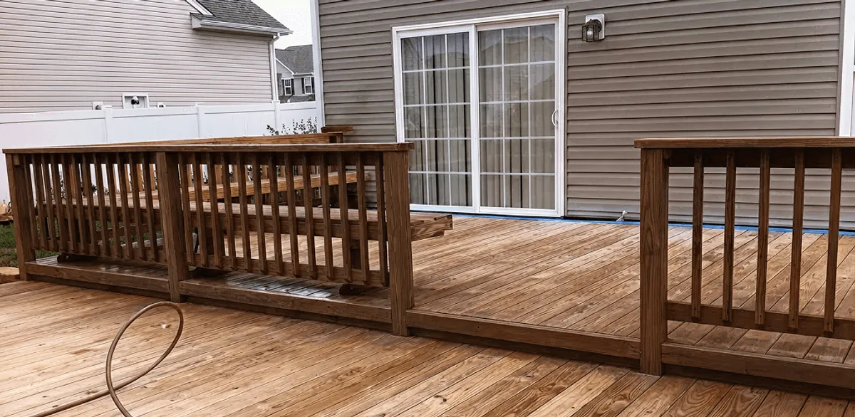 Deck sealing service protecting a backyard wood deck and railings in San Diego, CA