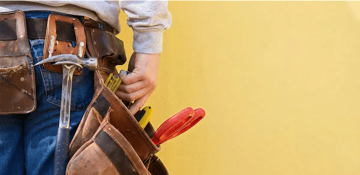 Handyman with tool belt ready for home repairs and maintenance in San Diego, CA
