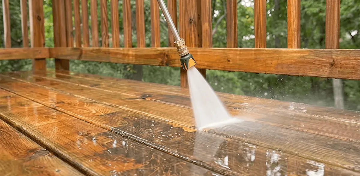 Pressure washing a wood deck to remove dirt and buildup in San Diego, CA
